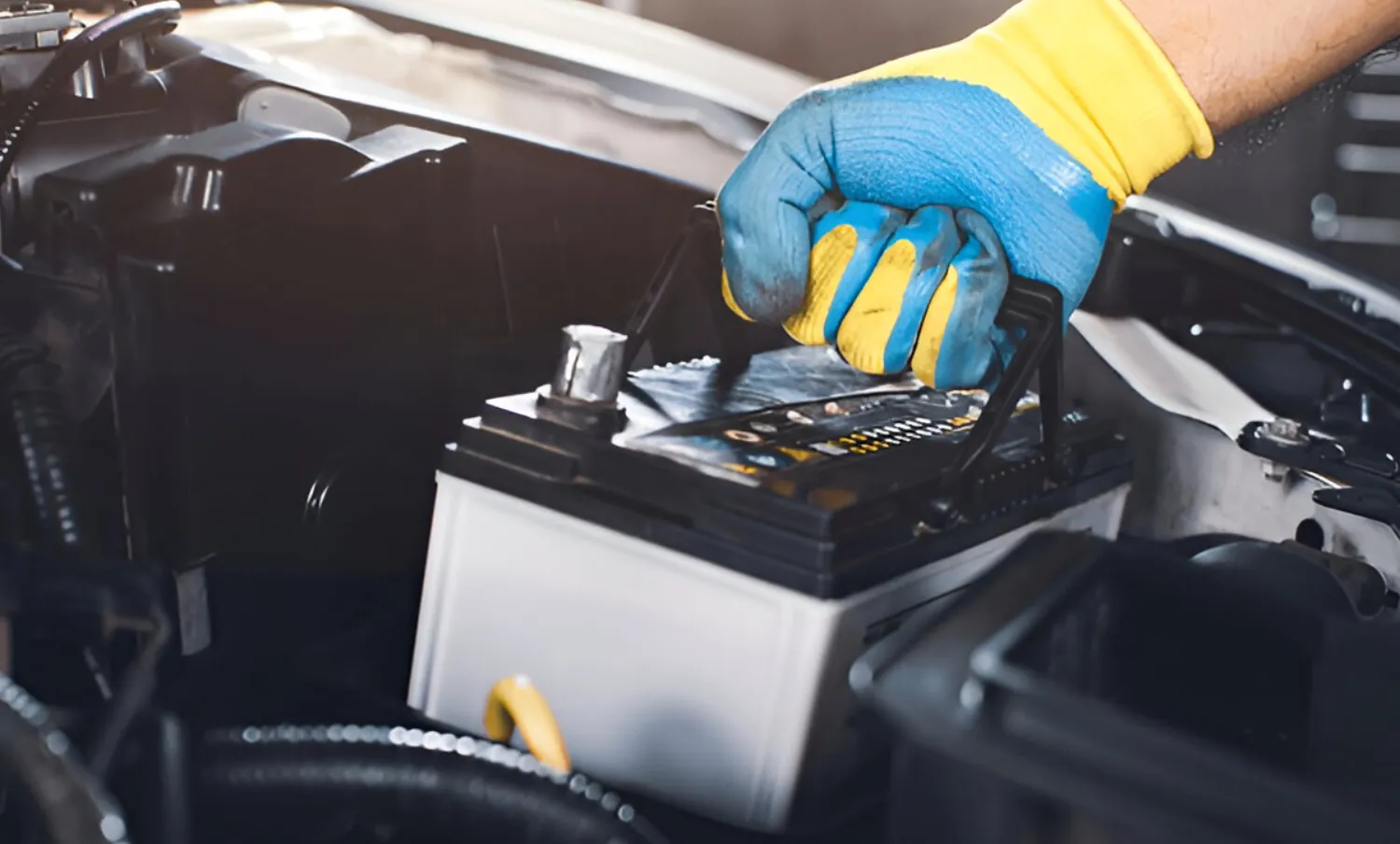 Battery technician installing new car battery